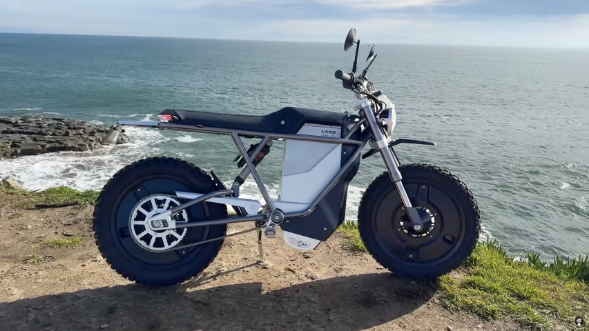 Discover the LAND Moto - District Scrambler, the perfect blend of e-bike and motorcycle with customizable modes, up to 70+ MPH speed, and 120 miles range for urban and off-road adventures.